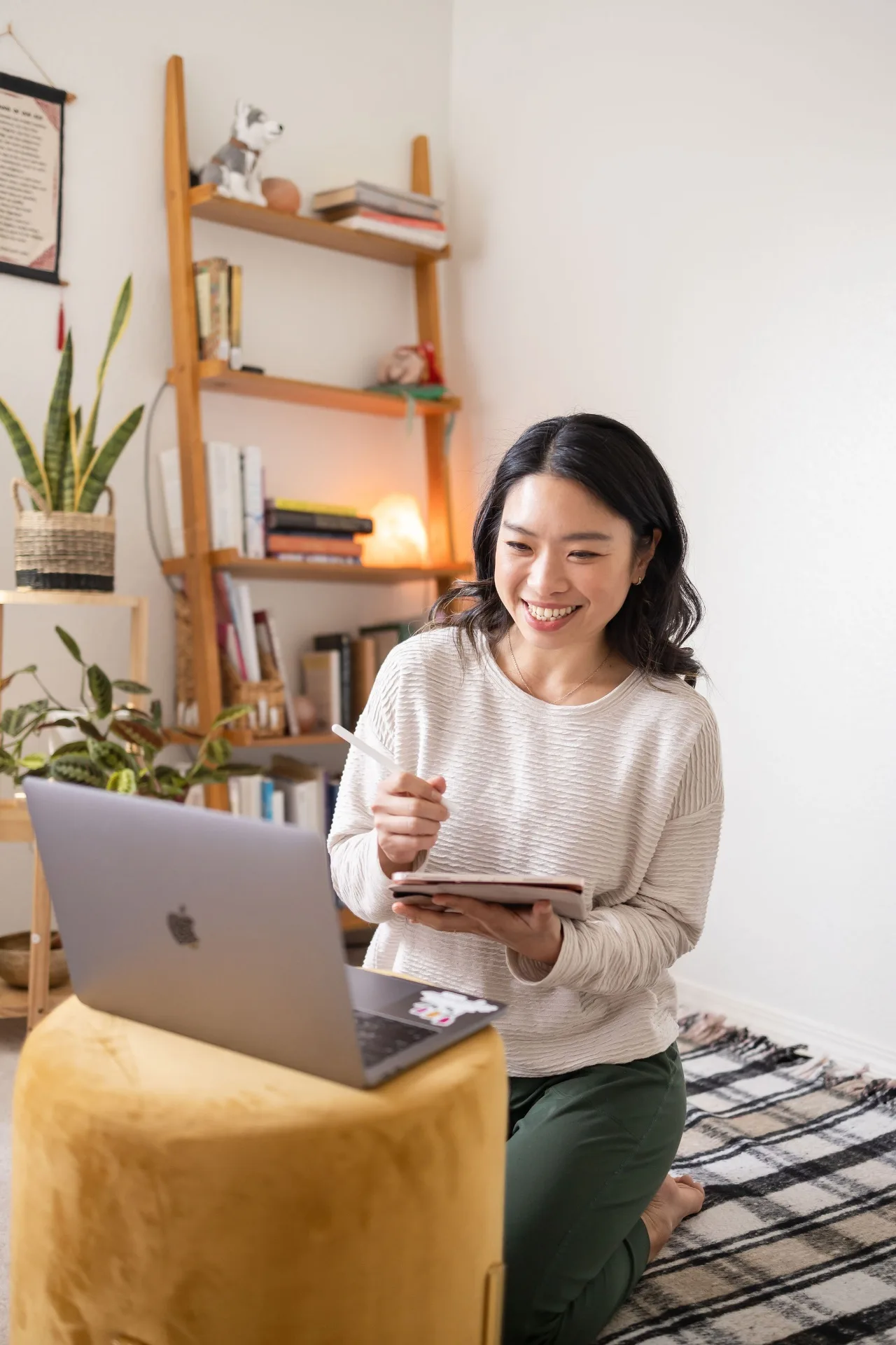 Elaine Oyang smiling during a 1:1 online yoga therapy session at her laptop